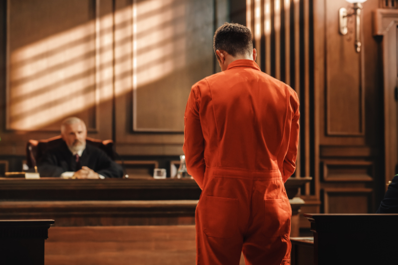 Man in orange jumpsuit standing in front of a judge. What is double jeopardy in Louisiana?