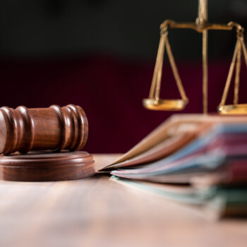 focus on hammer, group of files on judge table covered with dust - concept of pending old cases or work at judicial court
