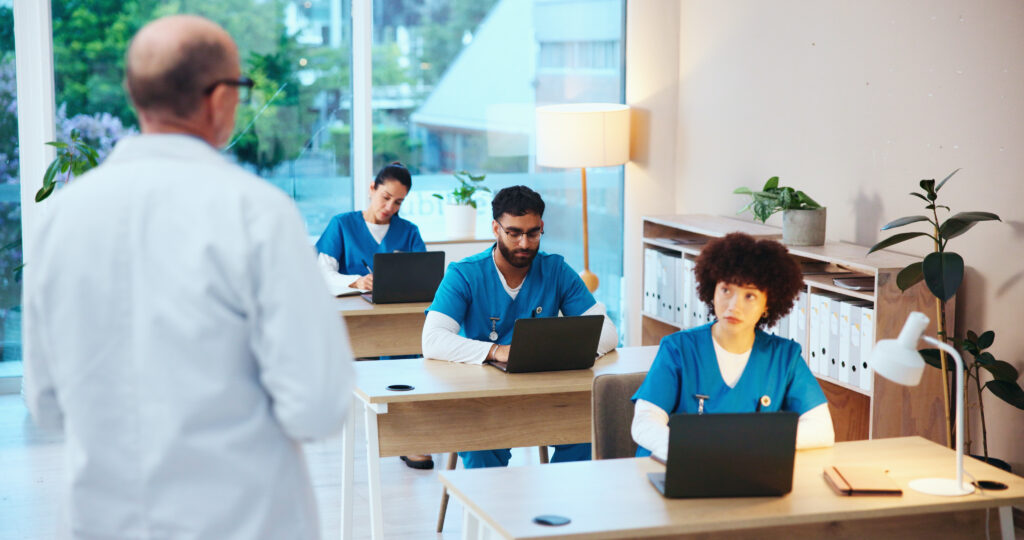 Healthcare, students and doctors with test, studying or knowledge of diseases, listening and classroom. Education, learning and people with info for medicine, laptop or skills for license in hospital.